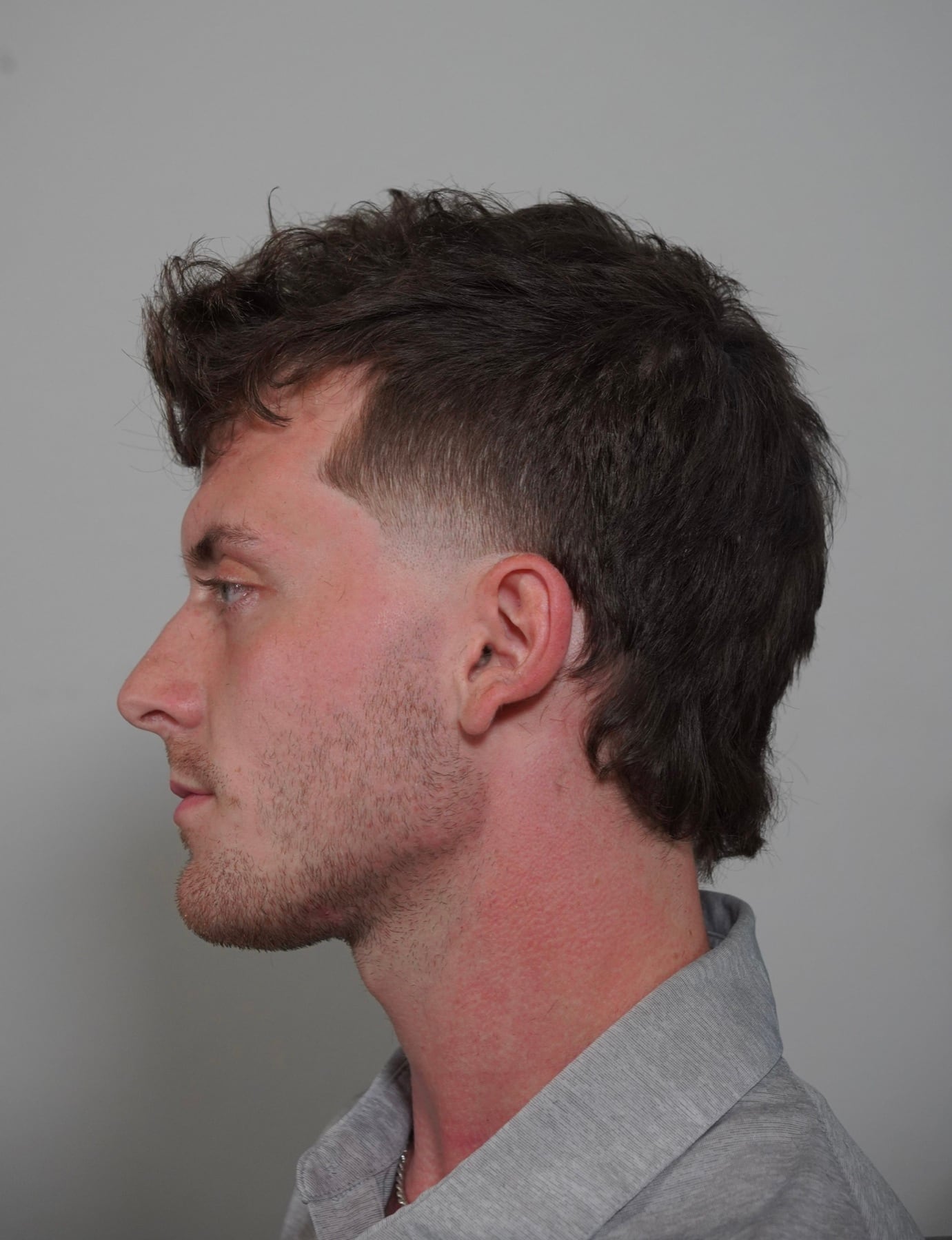 Dark layered haircut with a tapered side profile