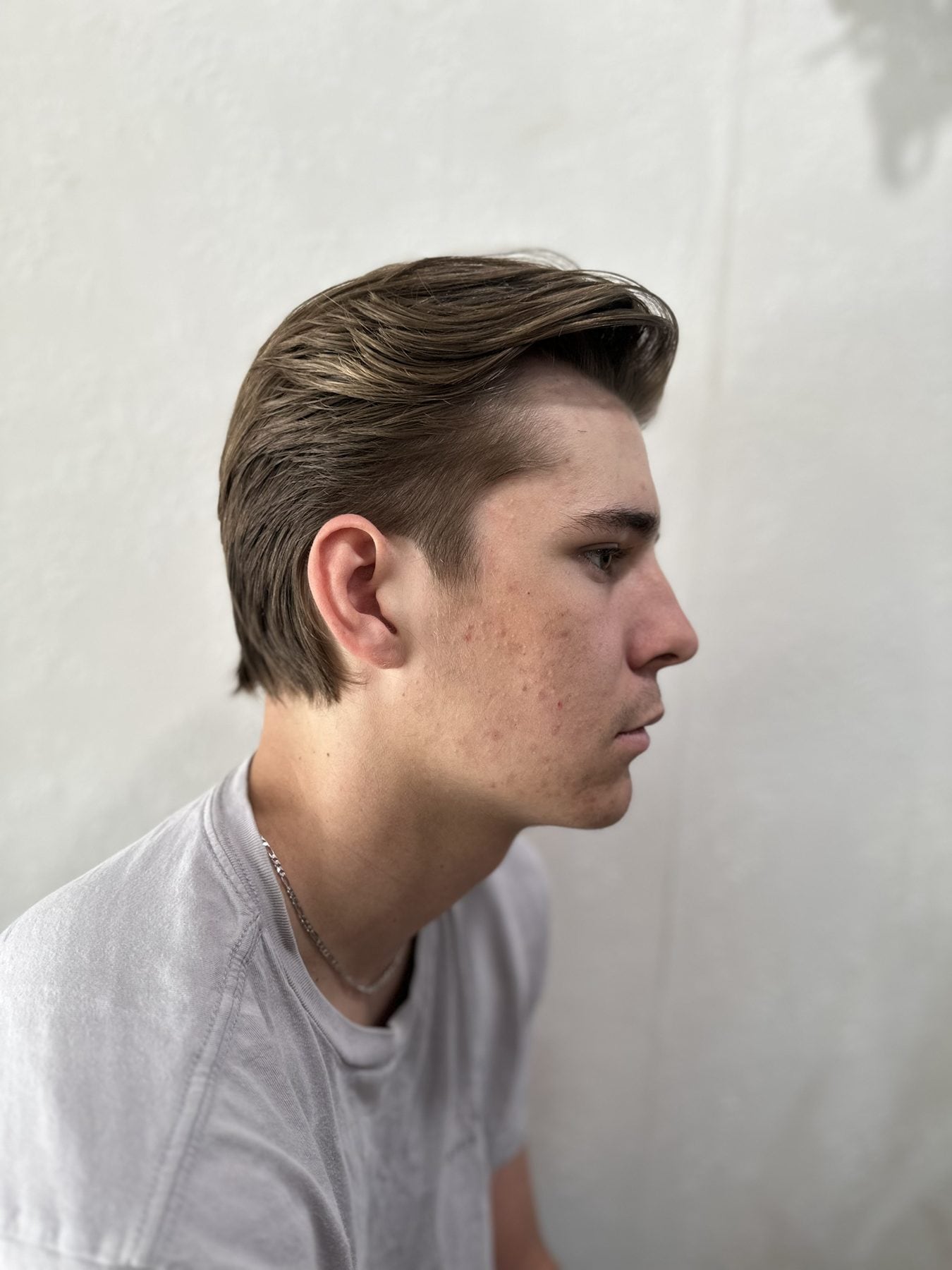 Sculpted medium-length brown haircut in profile