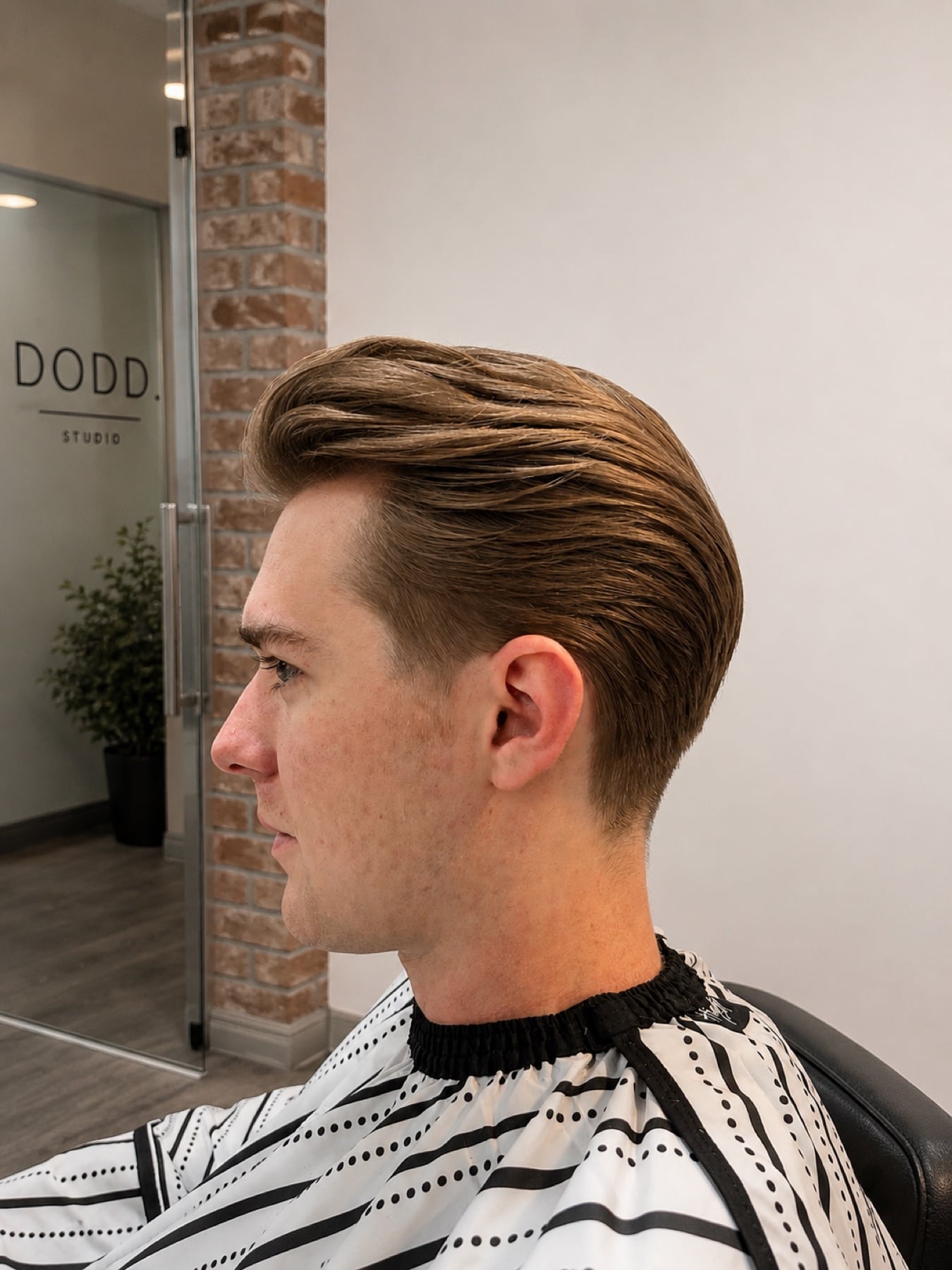 Slicked taper haircut with the Dodd. Studio sign